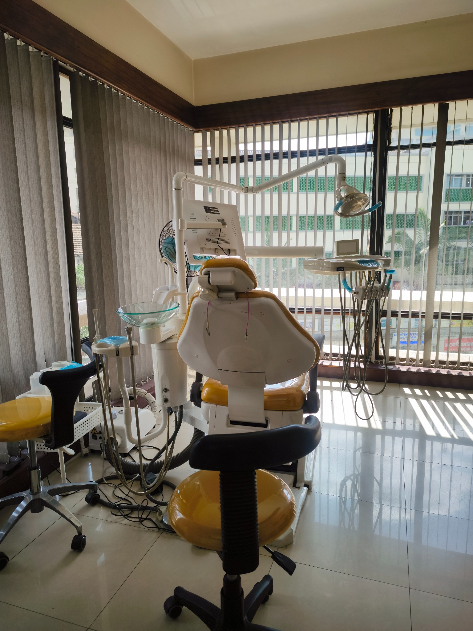 Dental treatment room with a procedure chair and equipment at Mint Dental Centre